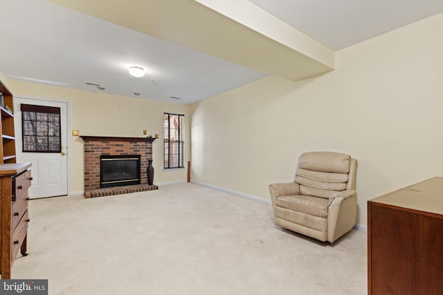 sitting room with a fireplace and light carpet