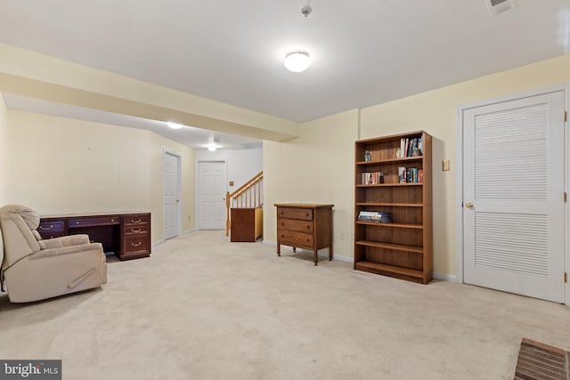 living area featuring light carpet