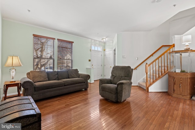 living room with wood-type flooring and ornamental molding