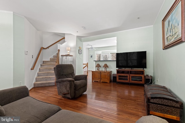 living room featuring ornamental molding and wood-type flooring