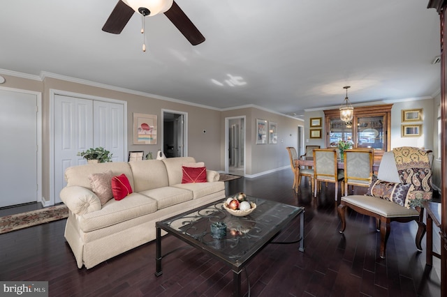 living room featuring dark wood-type flooring, ceiling fan, and ornamental molding