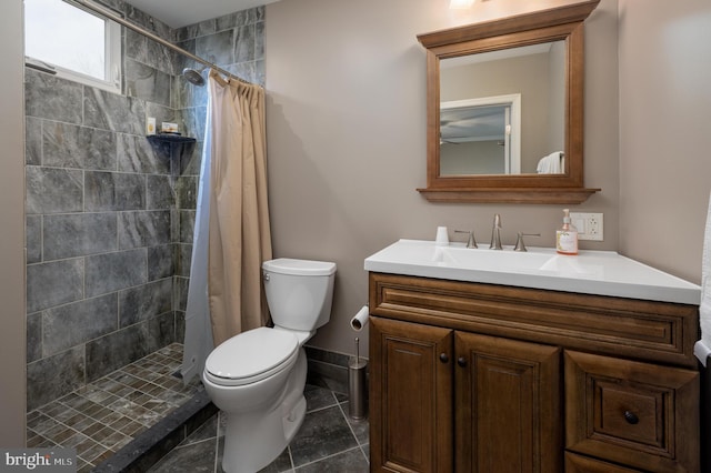 bathroom featuring vanity, toilet, curtained shower, and tile patterned flooring