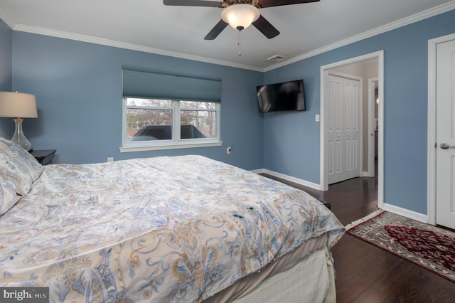 bedroom with crown molding, ceiling fan, dark hardwood / wood-style floors, and a closet