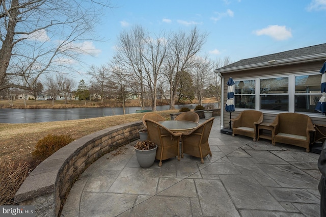 view of patio with a water view