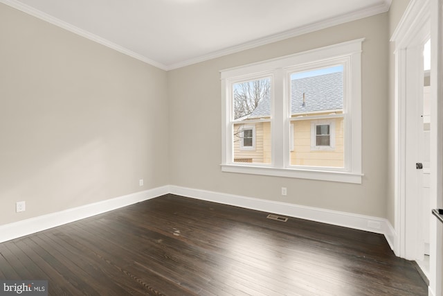 spare room featuring dark wood-type flooring and ornamental molding