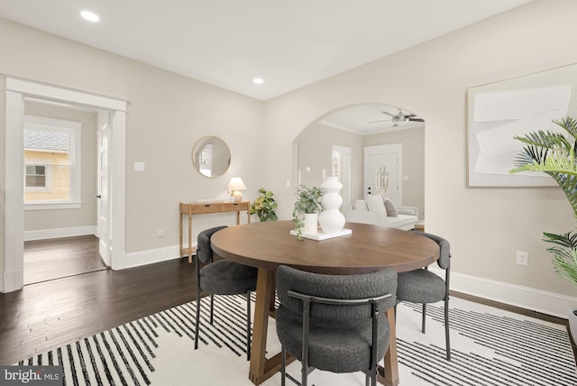 dining room with dark wood-type flooring and ceiling fan