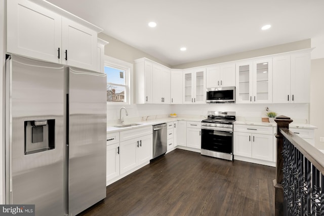 kitchen with white cabinetry, appliances with stainless steel finishes, sink, and dark hardwood / wood-style floors