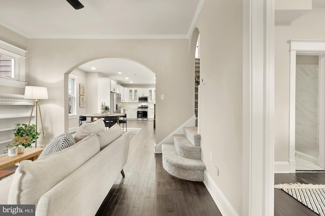 living room with dark wood-type flooring and crown molding