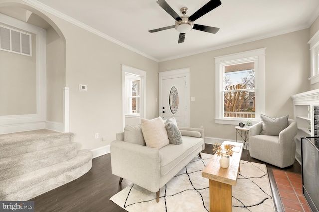 living room with hardwood / wood-style floors, crown molding, and ceiling fan