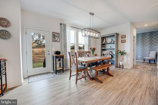 dining area featuring a notable chandelier and light hardwood / wood-style flooring