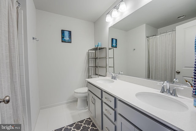 bathroom featuring vanity, tile patterned floors, and toilet