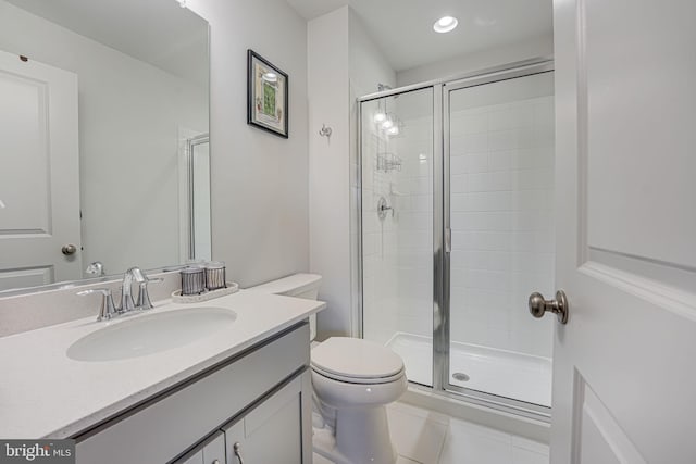 bathroom with a shower with door, vanity, and toilet