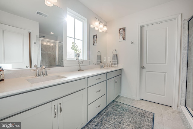 bathroom with vanity and a shower with door