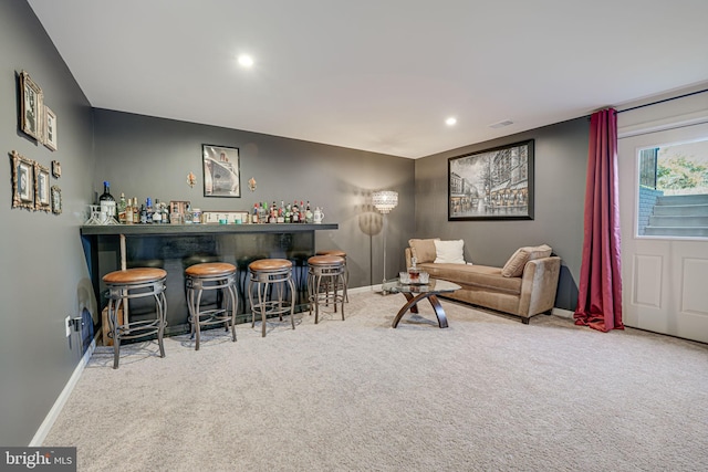 living room with light carpet and bar area