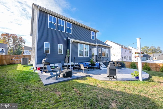 back of property featuring a patio, a lawn, central air condition unit, and a fire pit