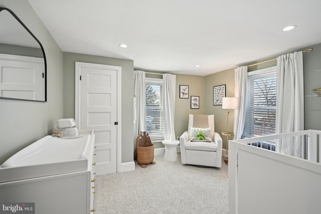 carpeted bedroom with multiple windows