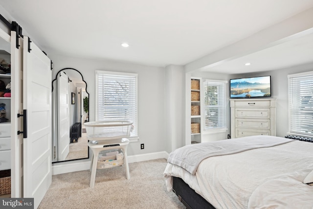 carpeted bedroom with a barn door