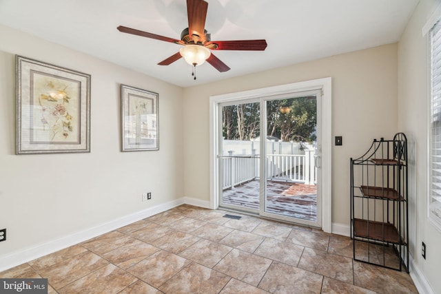 doorway to outside with light tile patterned flooring and ceiling fan