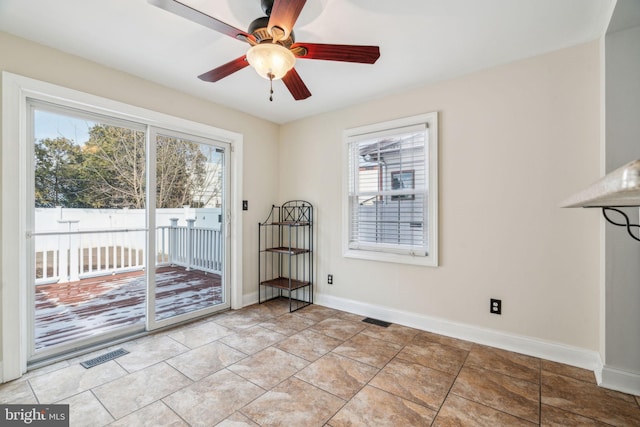 interior space with ceiling fan