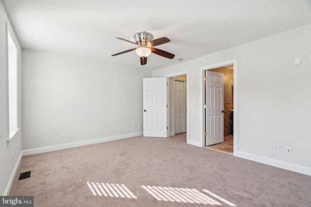 unfurnished bedroom featuring light colored carpet and ceiling fan