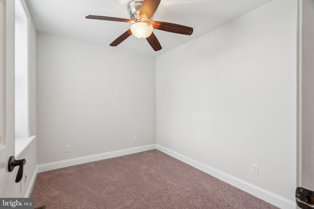 carpeted spare room with ceiling fan