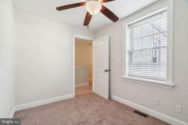 unfurnished bedroom featuring ceiling fan and light colored carpet