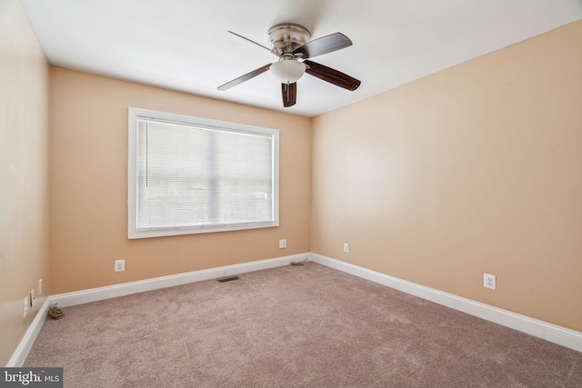 carpeted empty room featuring ceiling fan