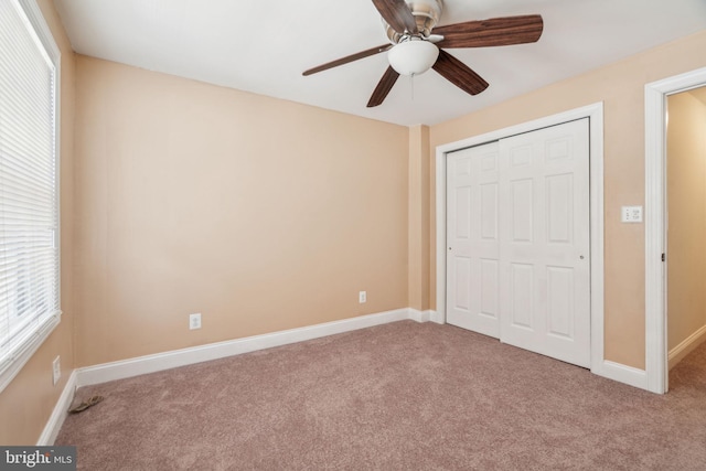 unfurnished bedroom with ceiling fan, carpet floors, and a closet