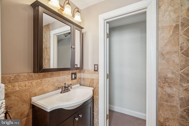 bathroom featuring tasteful backsplash, vanity, and tile walls