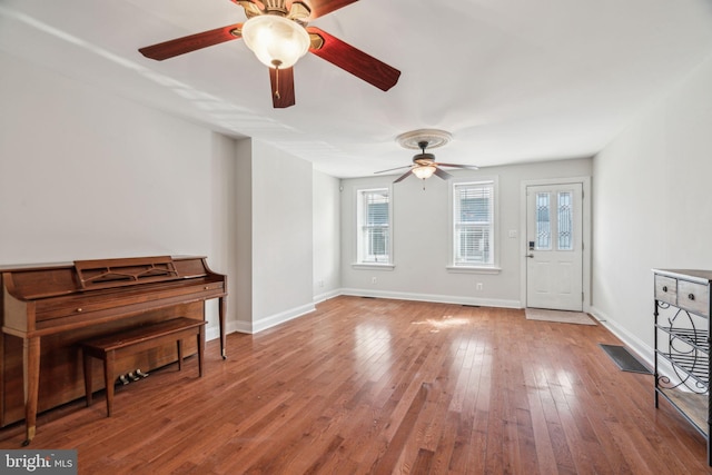 interior space with hardwood / wood-style flooring and ceiling fan