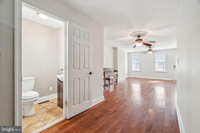 interior space with ceiling fan and light hardwood / wood-style floors