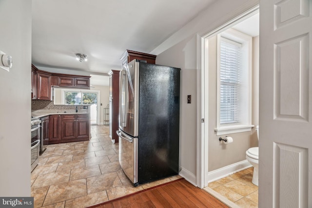 kitchen with backsplash and appliances with stainless steel finishes