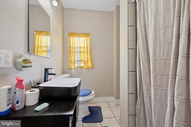 bathroom with sink, a shower, tile patterned floors, and toilet