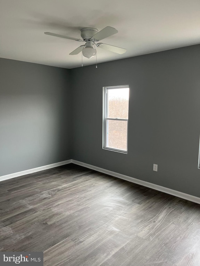 empty room with hardwood / wood-style flooring and ceiling fan