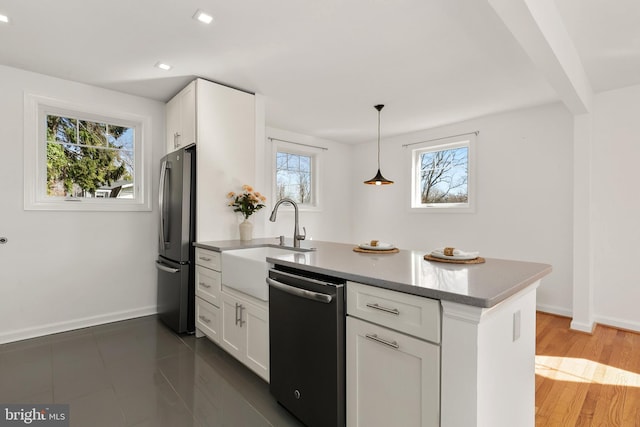 kitchen with white cabinetry, a healthy amount of sunlight, stainless steel appliances, and pendant lighting