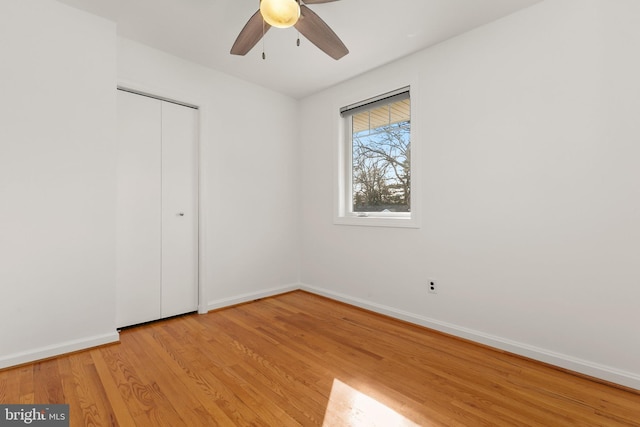 unfurnished bedroom with a closet, ceiling fan, and light hardwood / wood-style flooring