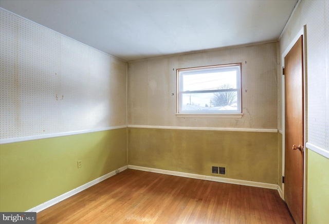 spare room with wood-type flooring