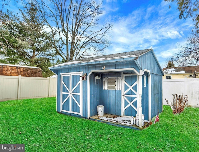 view of outdoor structure featuring a lawn