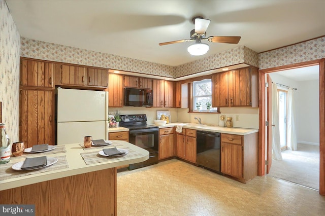 kitchen featuring sink, kitchen peninsula, ceiling fan, and black appliances