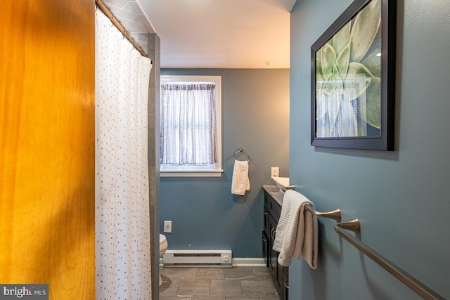 bathroom featuring vanity, toilet, baseboard heating, and walk in shower