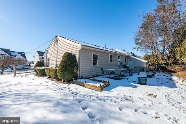 view of snow covered back of property