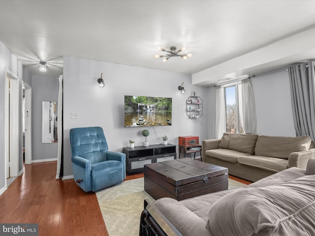 living room featuring wood-type flooring and a chandelier