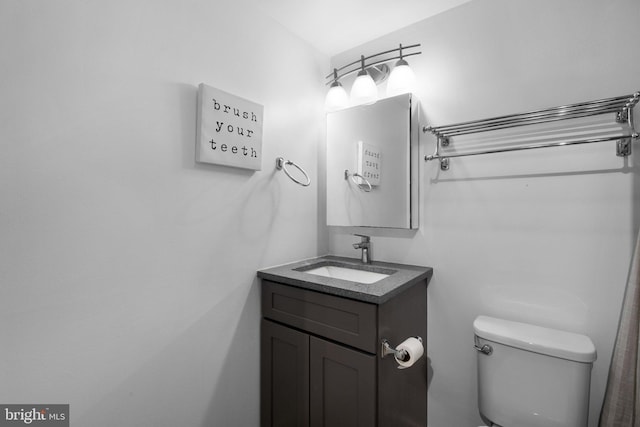 bathroom featuring vanity and toilet