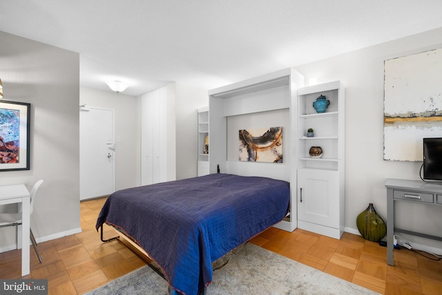 bedroom with light parquet flooring