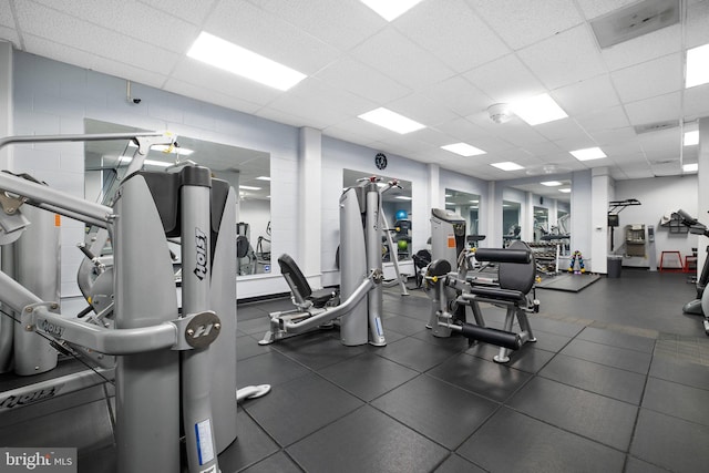 gym with a paneled ceiling