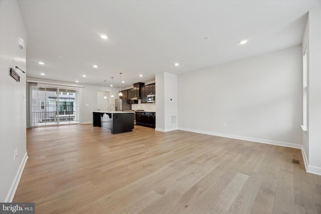 unfurnished living room featuring light hardwood / wood-style flooring