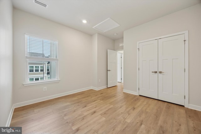 unfurnished bedroom featuring a closet and light hardwood / wood-style flooring