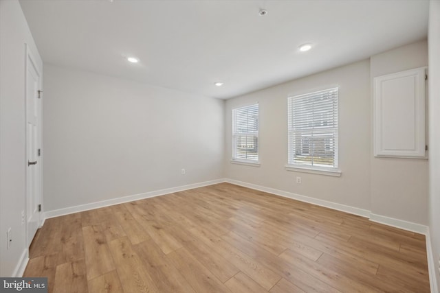 spare room featuring light hardwood / wood-style floors