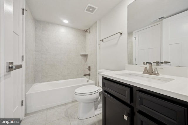 full bathroom featuring vanity, toilet, tiled shower / bath combo, and tile patterned flooring