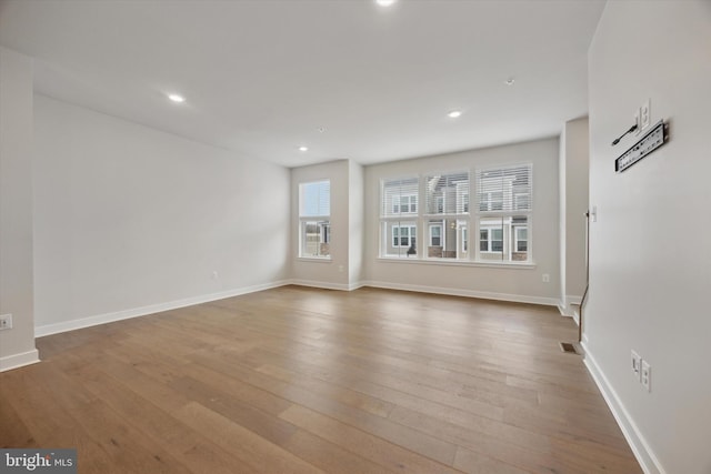 unfurnished living room featuring hardwood / wood-style floors